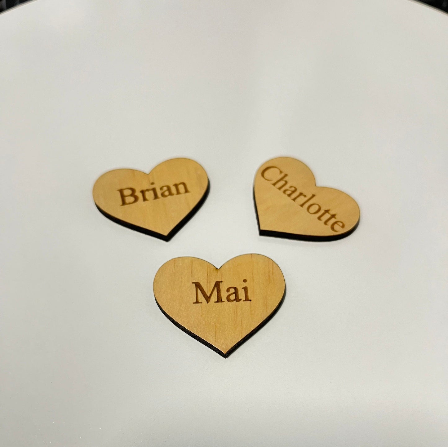 Custom family tree additions wooden heart-shaped tags engraved with names Brian Charlotte and Mai